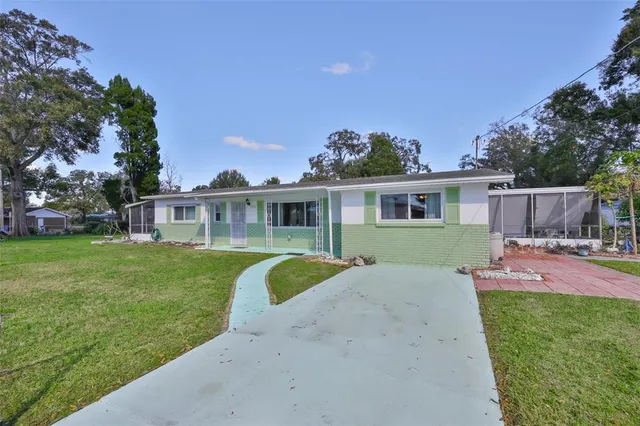 a view of a house with a backyard