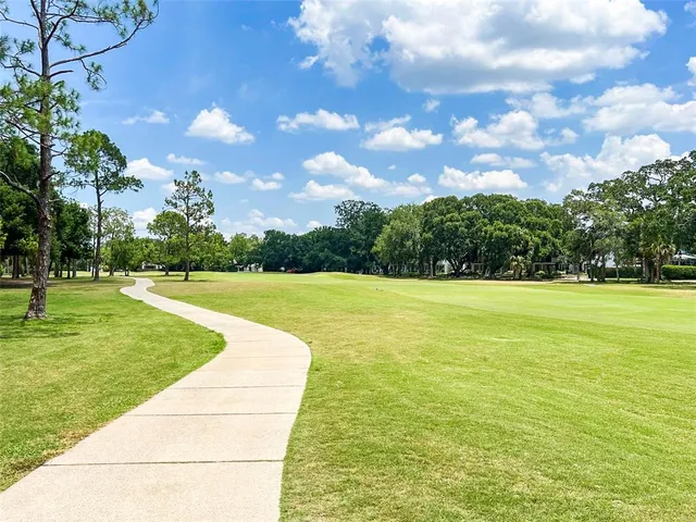 a view of building with swimming pool and green space