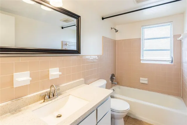 a bathroom with a sink a toilet and a bathtub