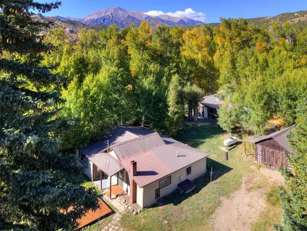 an aerial view of a house with a yard