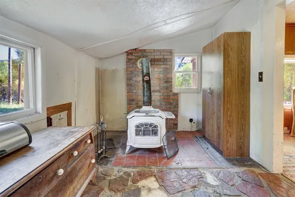 a view of a hallway with entryway wooden floor and windows