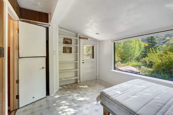 a view of kitchen with furniture and refrigerator