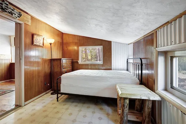 a bedroom with a bed dresser and a large mirror