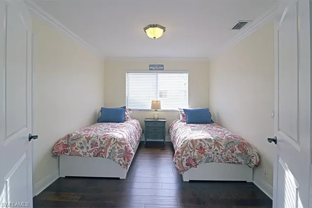 a bedroom with two beds and a window