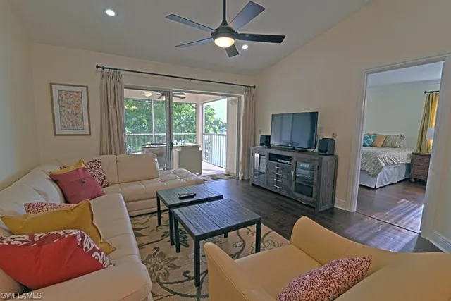 a living room with furniture ceiling fan and a window