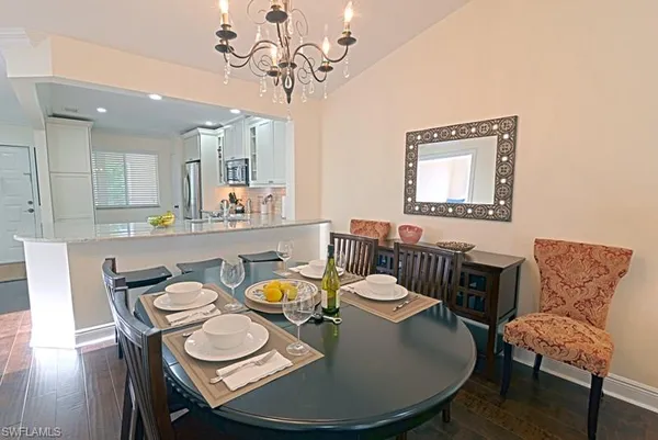 a dining room with furniture a rug and wooden floor