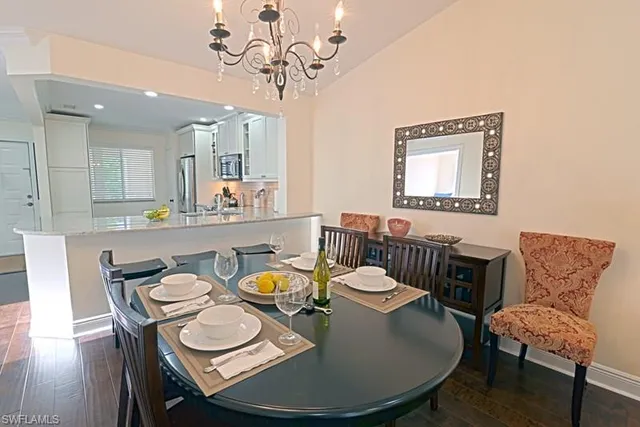 a dining room with furniture a rug and wooden floor