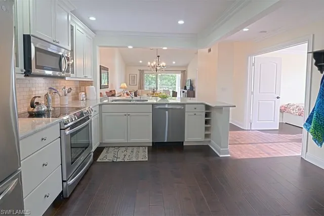a kitchen with stainless steel appliances granite countertop wooden cabinets and sink