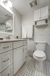 a bathroom with a sink toilet and shower