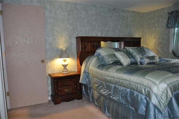 108 Clark Road Sturbridge, MA 01518 - Photo 12 of 30 a bedroom with a bed and a lamp on table