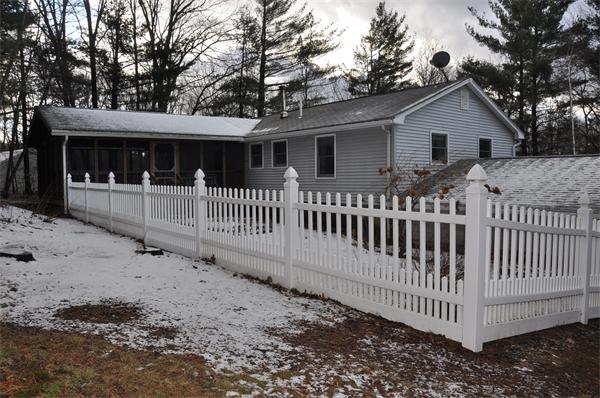 108 Clark Road Sturbridge, MA 01518 - Photo 30 of 30 a view of a house with a small yard and wooden fence