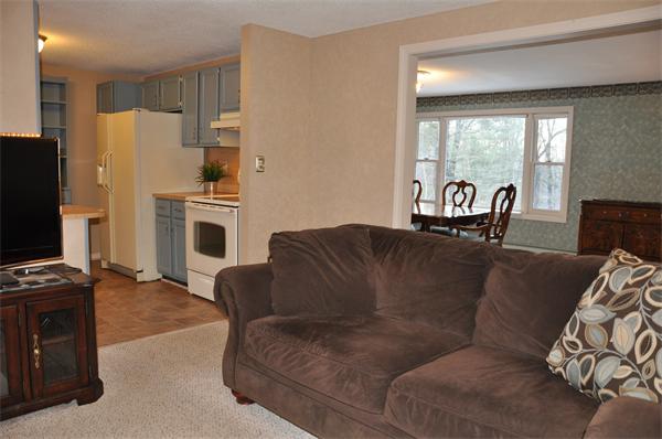 108 Clark Road Sturbridge, MA 01518 - Photo 6 of 30 a living room with furniture a large window with kitchen view