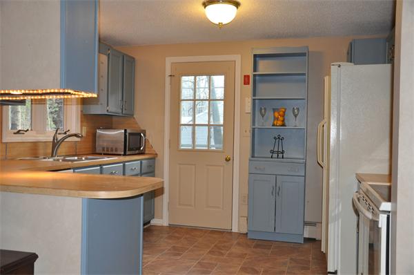 108 Clark Road Sturbridge, MA 01518 - Photo 7 of 30 a kitchen with refrigerator cabinets and a sink