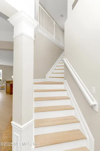 a dining room with furniture and a floor to ceiling window