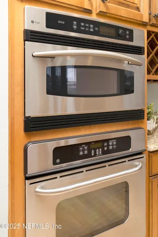 a stove top oven sitting inside of a kitchen