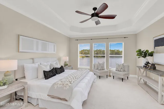 a living room with furniture a large window and a fireplace