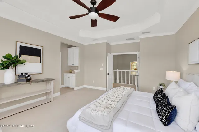 a spacious bedroom with a bed a couch and a large window