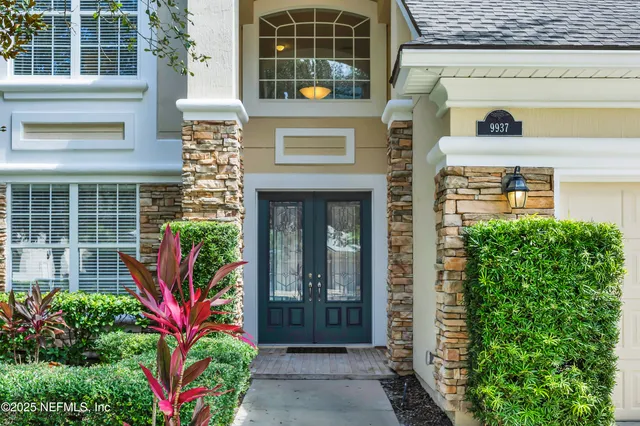 a view of a living room filled with furniture windows