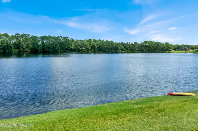 a view of a lake with houses in the background