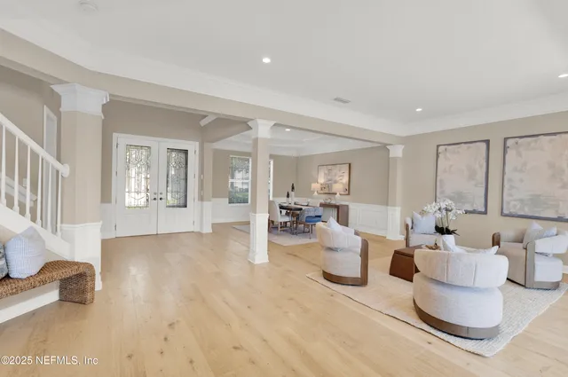 a living room with furniture and large window