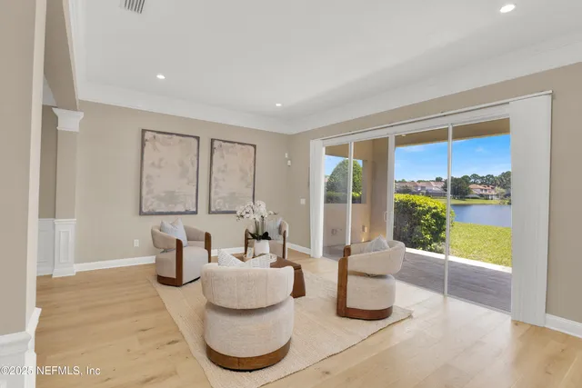 a view of a livingroom with wooden floor and a ceiling fan