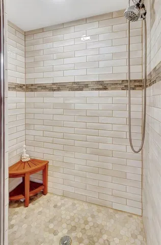 a bedroom with a bed and a flat tv screen on a dresser