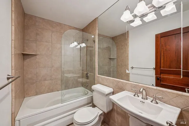 a bathroom with a bathtub a sink and a large mirror