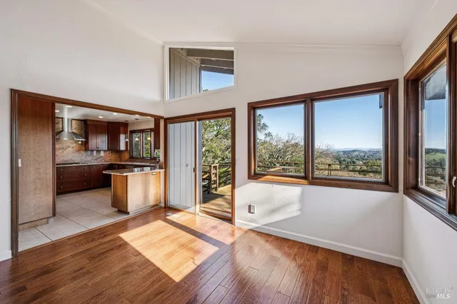 a open kitchen with granite countertop a refrigerator a sink and wooden cabinets