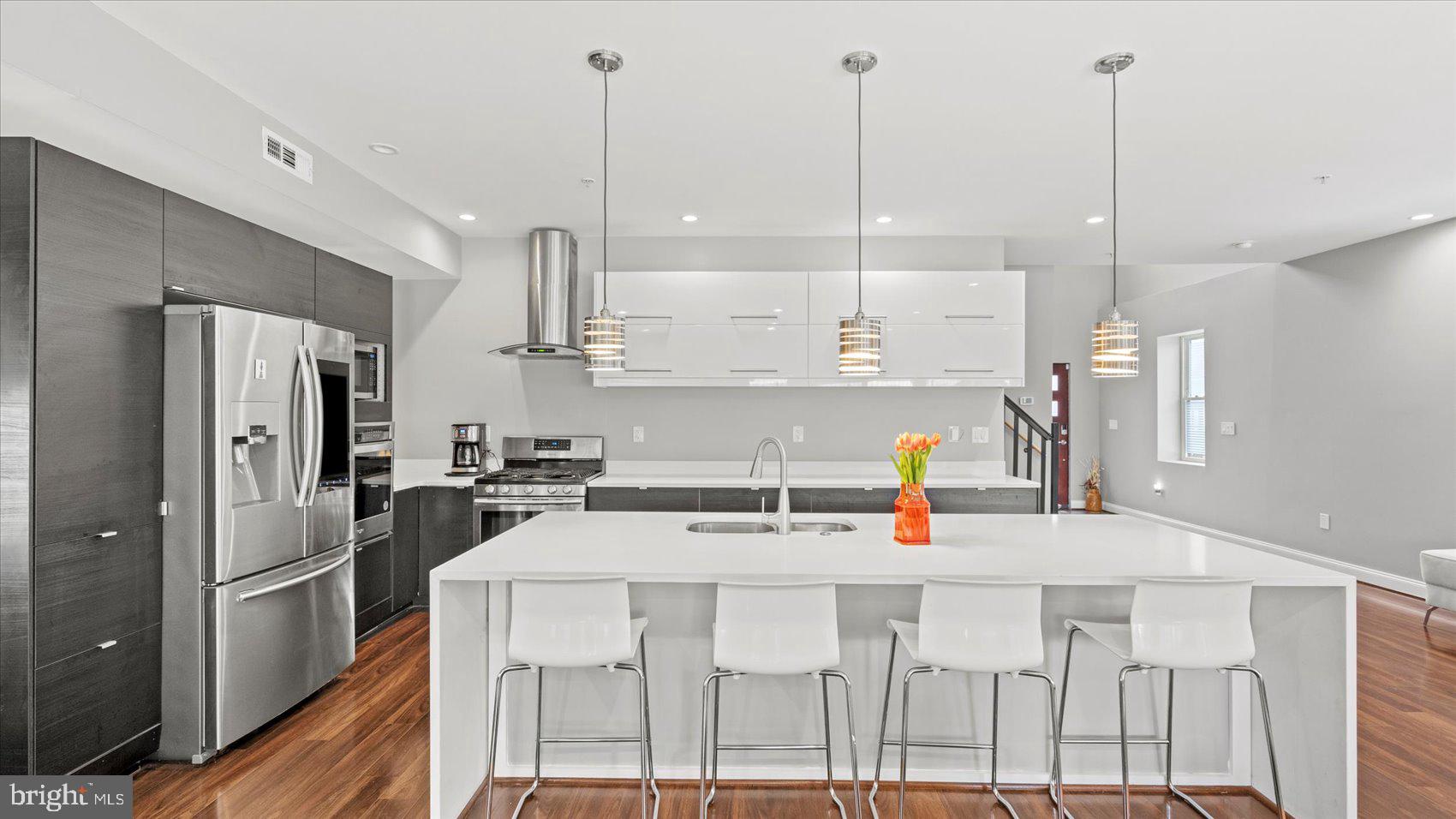3145 Baybriar Road Dundalk, MD 21222 - Photo 17 of 54 a kitchen with stainless steel appliances kitchen island wooden cabinets and white appliances