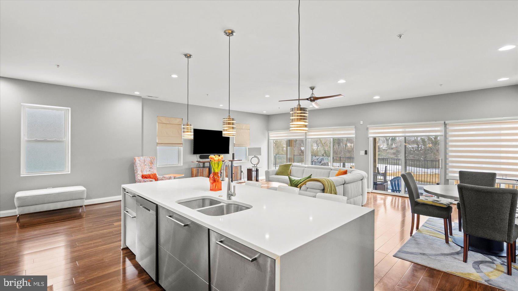 3145 Baybriar Road Dundalk, MD 21222 - Photo 22 of 54 a view of a dining room and livingroom with furniture wooden floor a rug a flat screen tv a painting and a chandelier