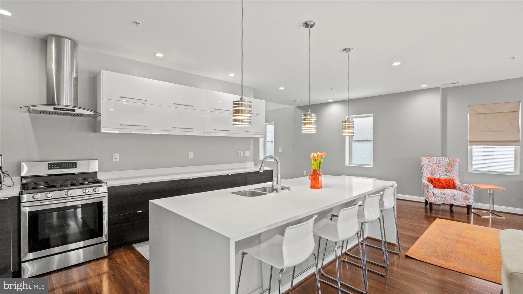 3145 Baybriar Road Dundalk, MD 21222 - Photo 25 of 54 a kitchen with a sink a stove and chairs