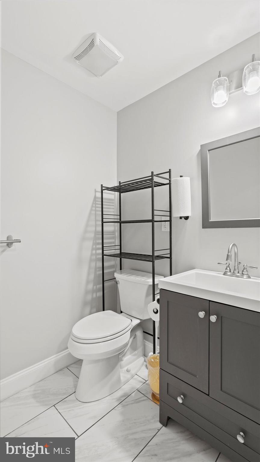 3145 Baybriar Road Dundalk, MD 21222 - Photo 51 of 54 a bathroom with a toilet a sink and mirror