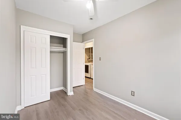 a view of empty room with wooden floor and entryway