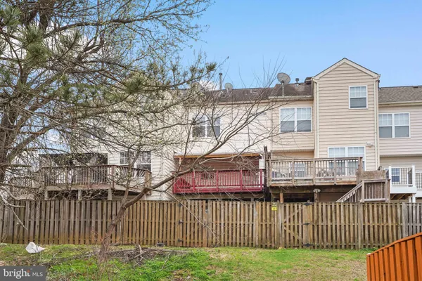 a view of a house with a yard and fence