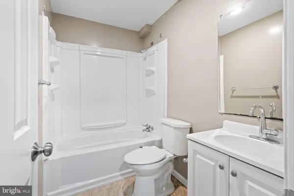a bathroom with a sink toilet vanity and shower