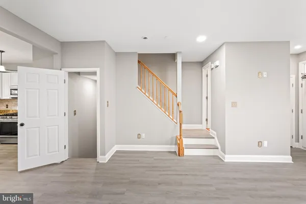 a view of entryway and hall with wooden floor