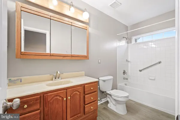 a kitchen with stainless steel appliances granite countertop a refrigerator a stove a sink and white cabinets