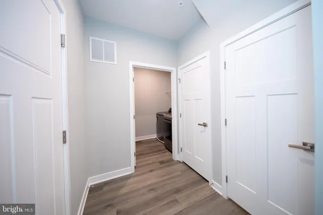 a view of a hallway with wooden floor