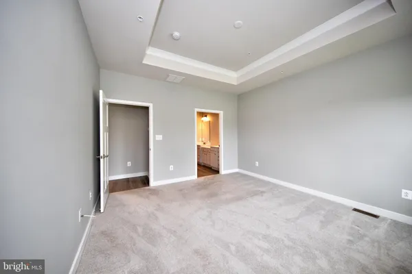 an empty room with window and wooden floor