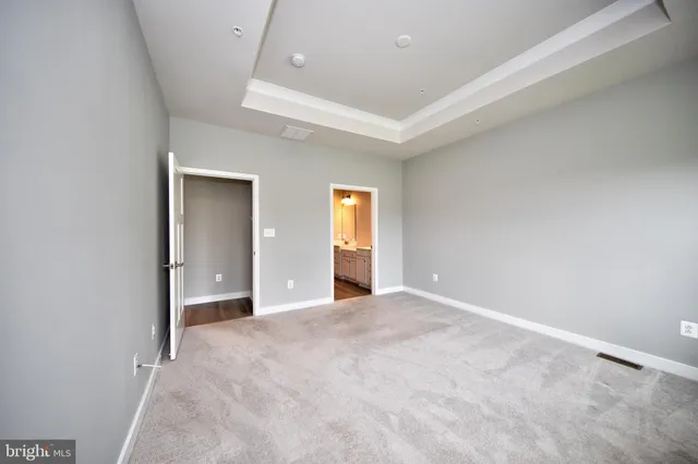 an empty room with window and wooden floor