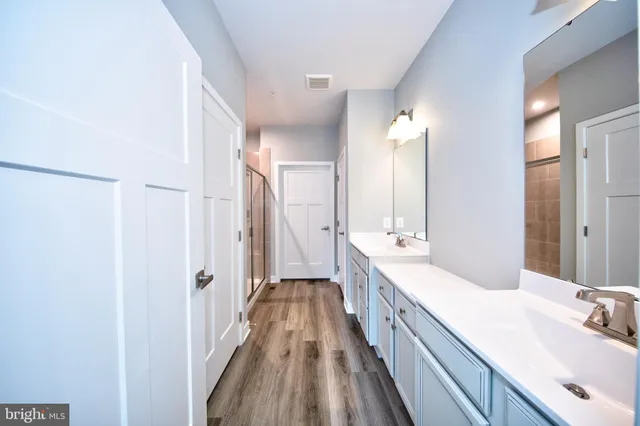a bathroom with a double vanity sink and mirror