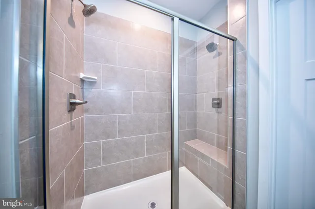 a bathroom with a shower and a sink