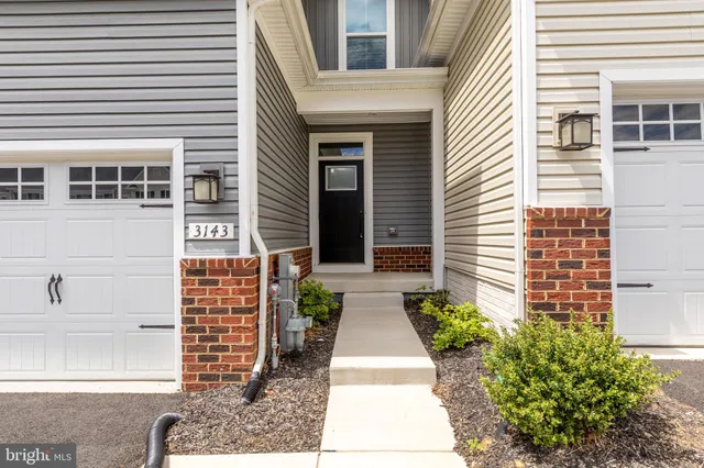 a house with potted plants in front of door