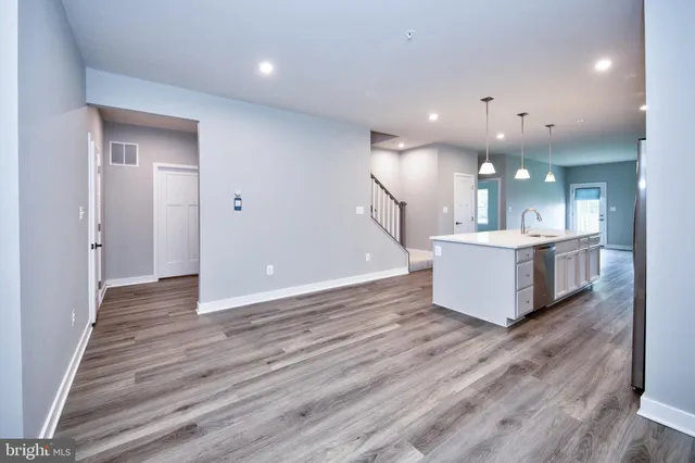 a view of kitchen with sink and wooden floor