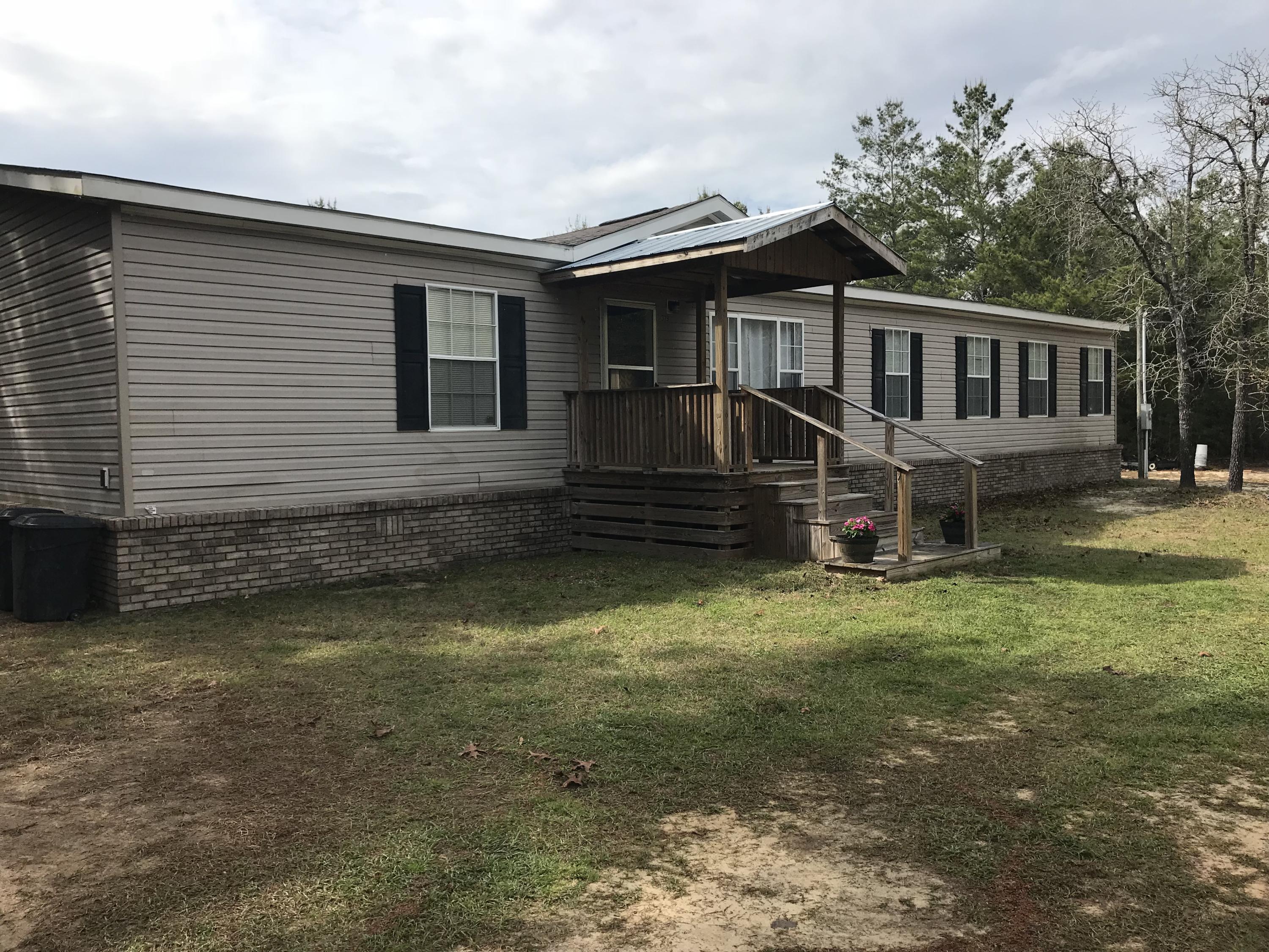319 Delaware Road DeFuniak Springs, FL 32433 - Photo 1 of 22 a front view of a house with a yard