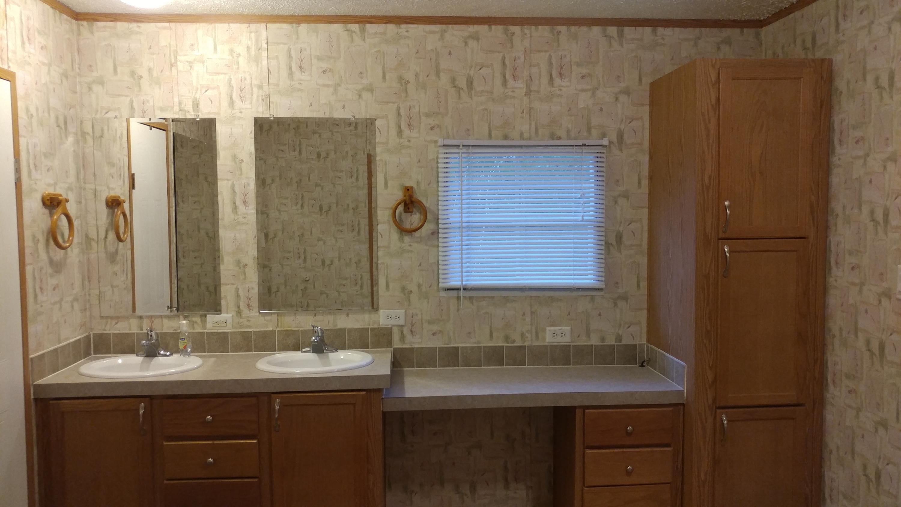 319 Delaware Road DeFuniak Springs, FL 32433 - Photo 11 of 22 a bathroom with a sink and mirror