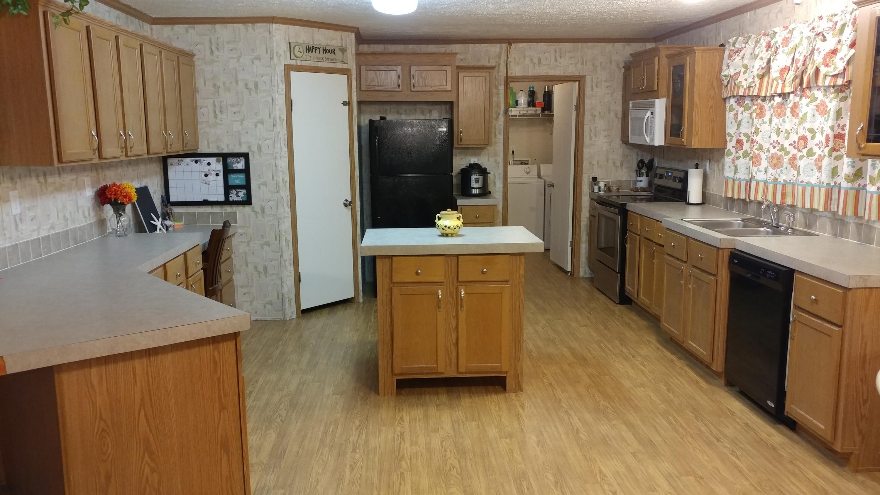 319 Delaware Road DeFuniak Springs, FL 32433 - Photo 4 of 22 a kitchen with stainless steel appliances granite countertop a refrigerator a stove and a sink