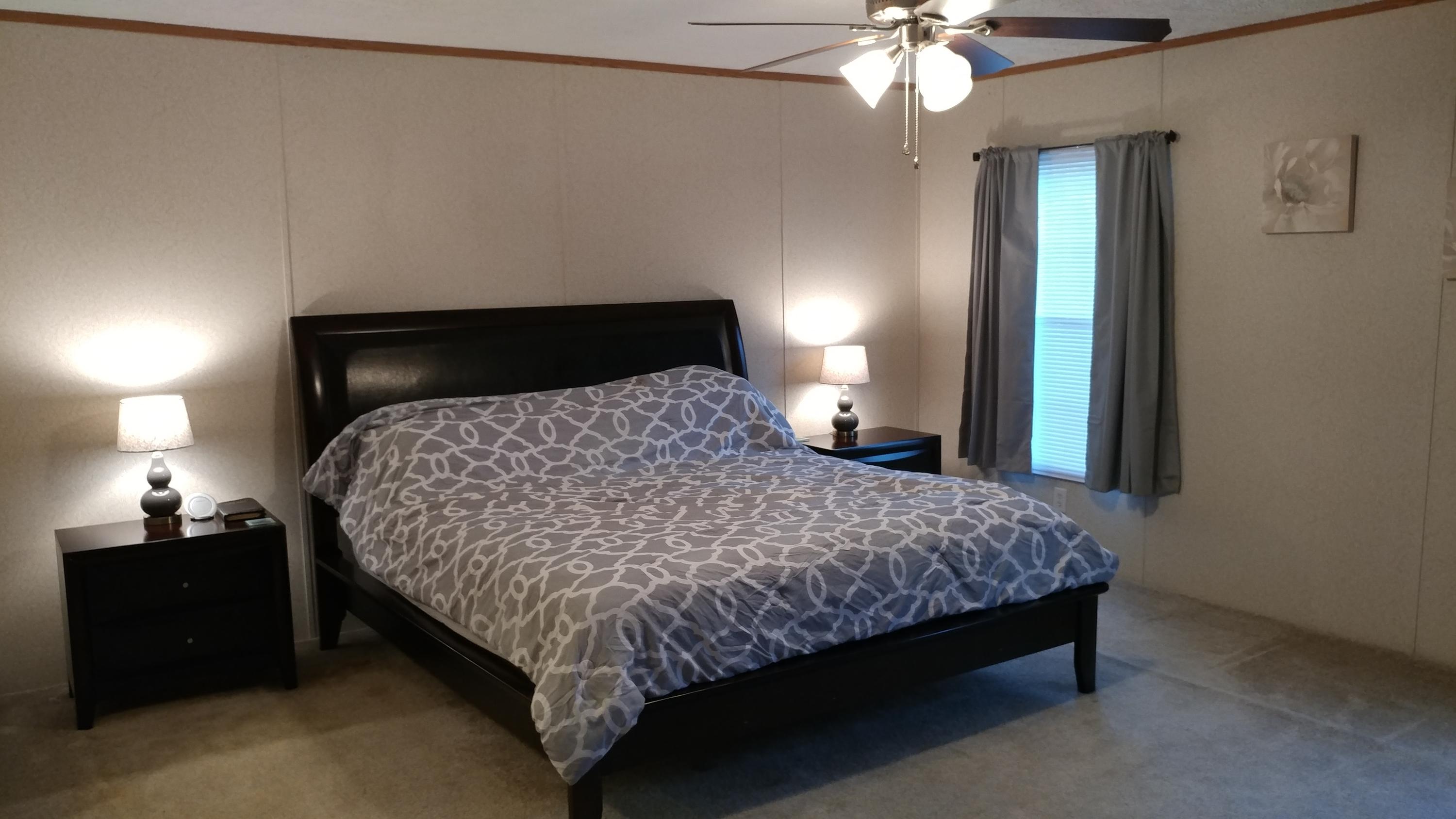 319 Delaware Road DeFuniak Springs, FL 32433 - Photo 7 of 22 a bedroom with a bed and a chandelier