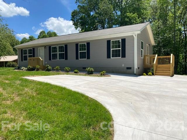 a front view of a house with a yard and porch