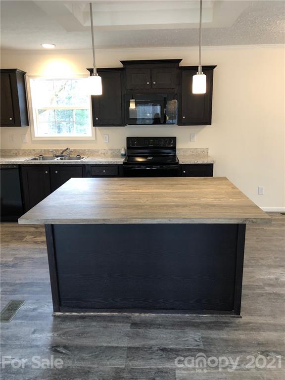 318 Souther Road Fletcher, NC 28732 - Photo 11 of 19 a kitchen with kitchen island sink and stove
